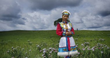 A young Mongolian girl is in the field