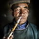A traditional pipe is smoked by a Mongolian