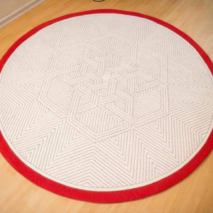 An embroidered round felt rug